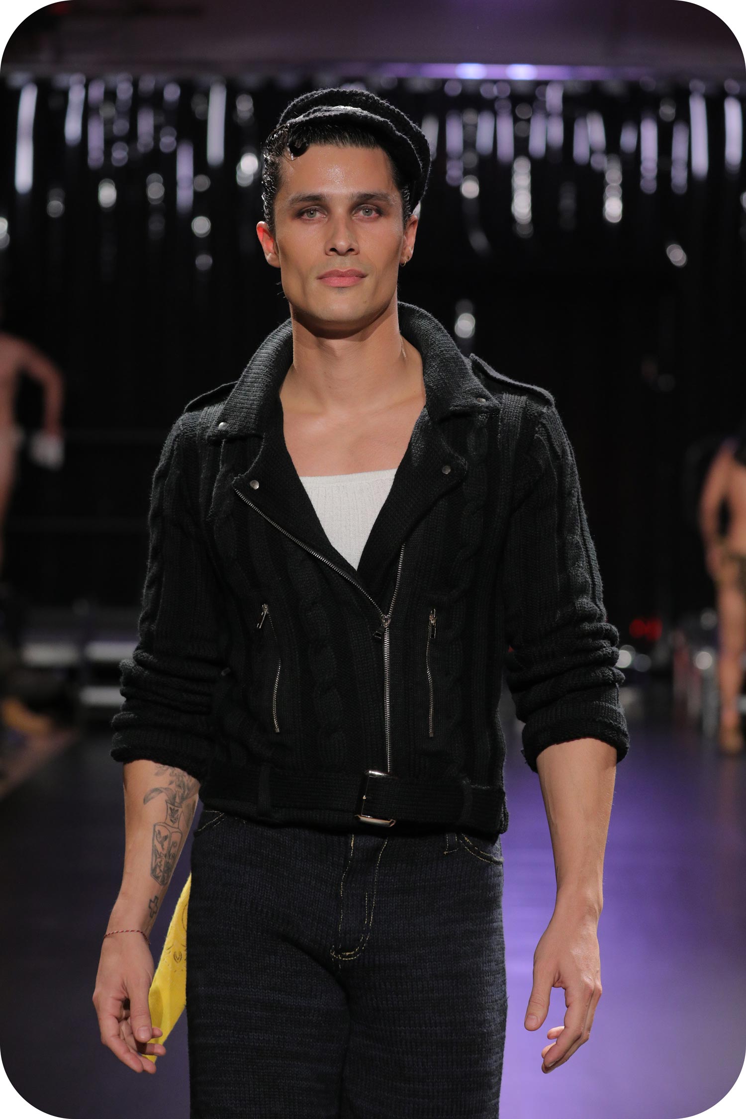 A man wearing a black blazer made of gay wool