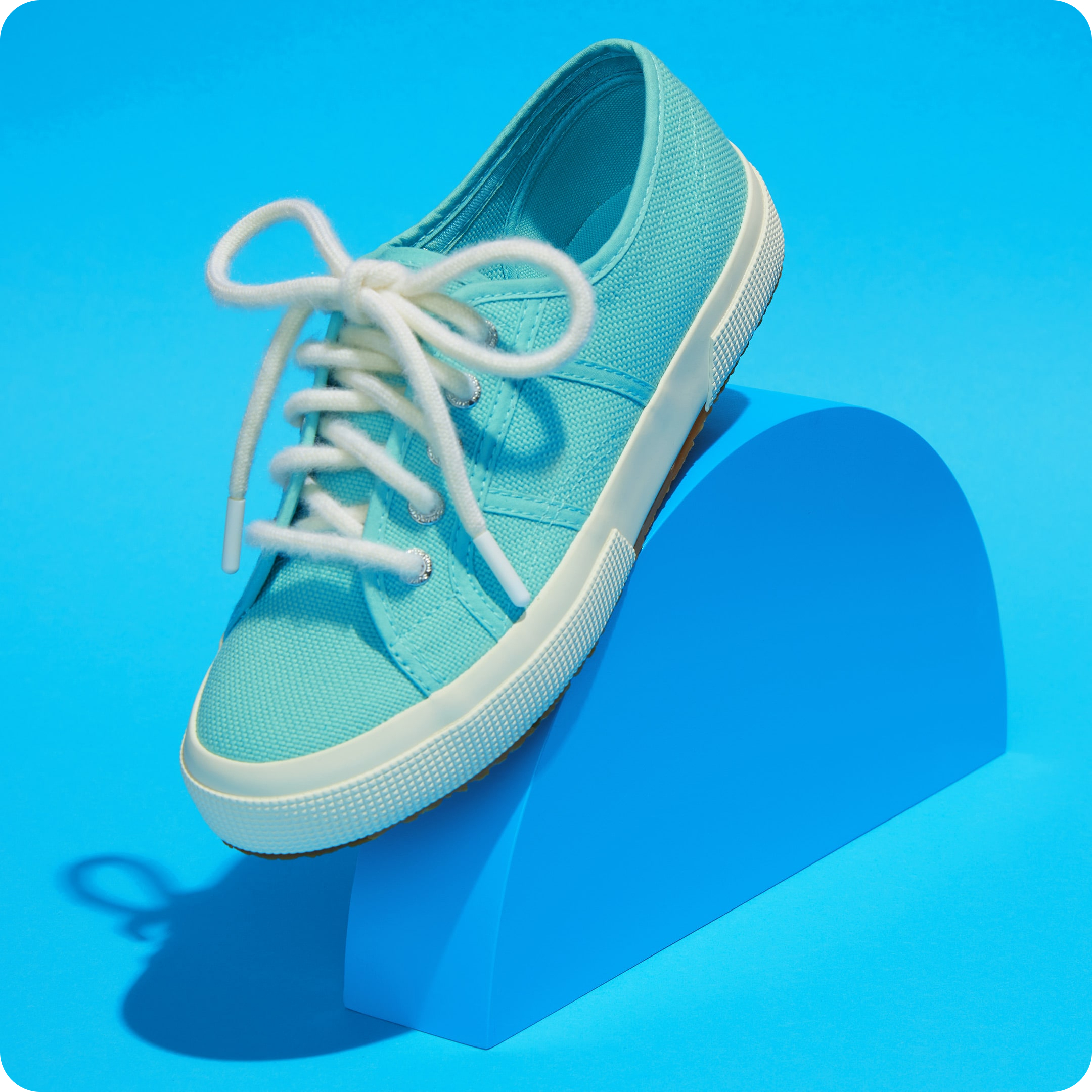 Rainbow Wool Laces made of gay sheep wool  on a colorful sneaker  in front of a colorful background.