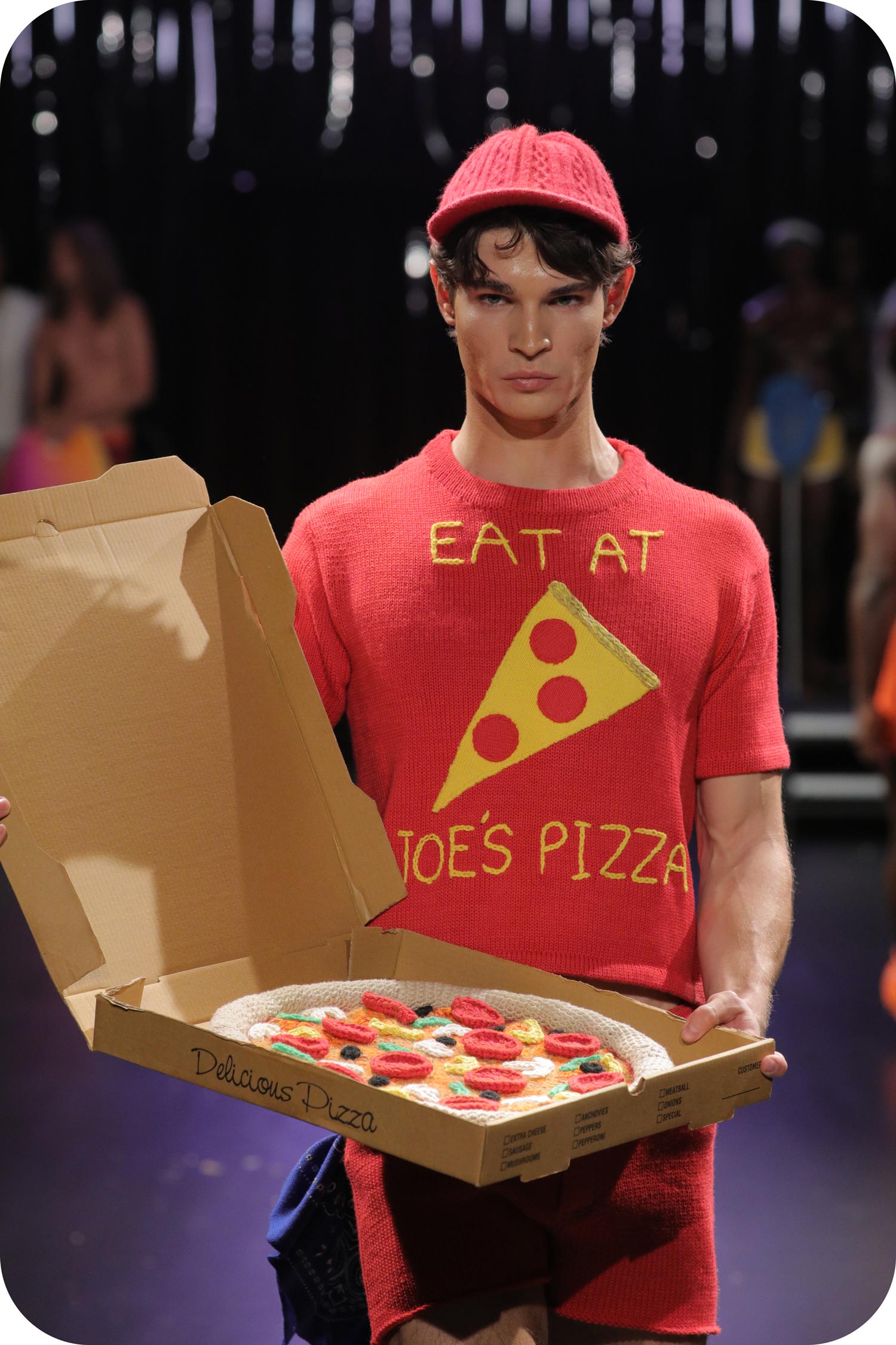 A man wearing red pizza delivery outfit made of gay wool